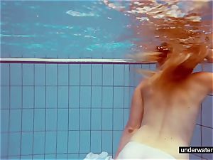 nice red-haired plays bare underwater